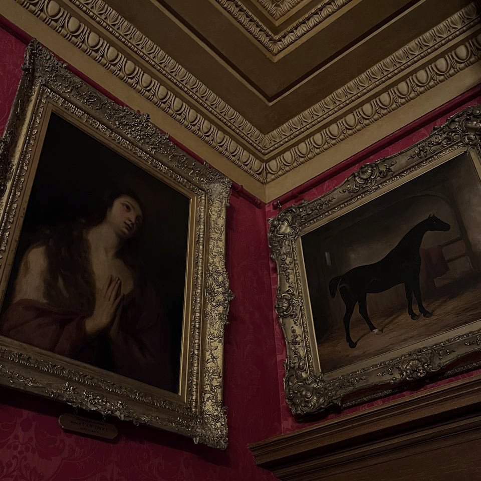 Image displaying 2 painings in a room with red walls